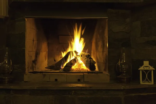 Wood fire burning in a stone fireplace