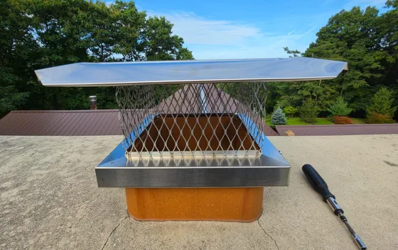 Stainless chimney cap seated on a freshly rebuilt crown