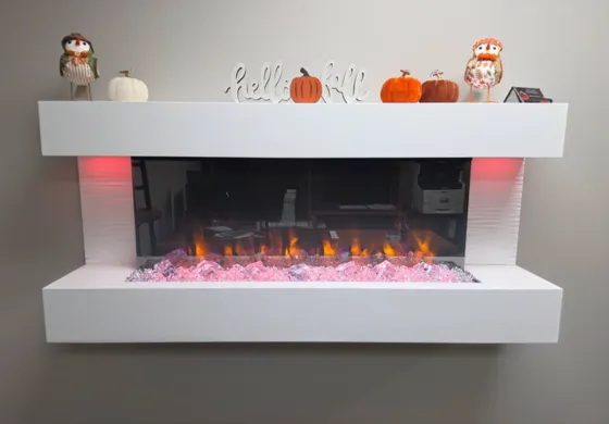 Wall-mounted electric fireplace running in a finished room